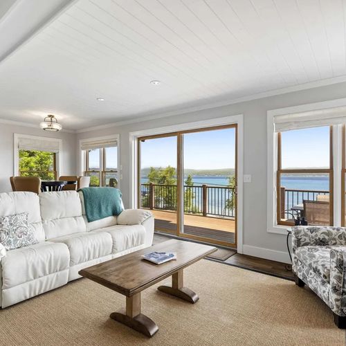 LIVING ROOM (MAIN FLOOR):  The home has a stunning living room with a spectacular view of Crystal Lake and a natural gas fireplace