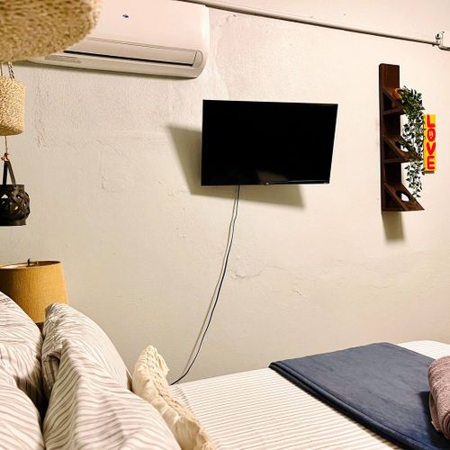 A cozy bed and a TV for a perfect night in.