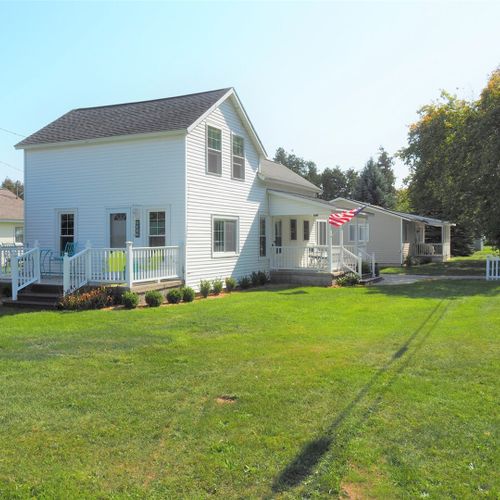Exterior:  a side angle of the house in summer.
