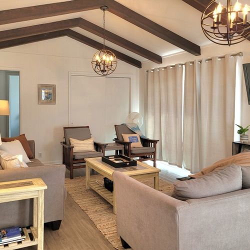 Living room:  the cottage features a very bright, modern, and fun living room with a beachy design and a wall-mounted television with live streaming via roku.