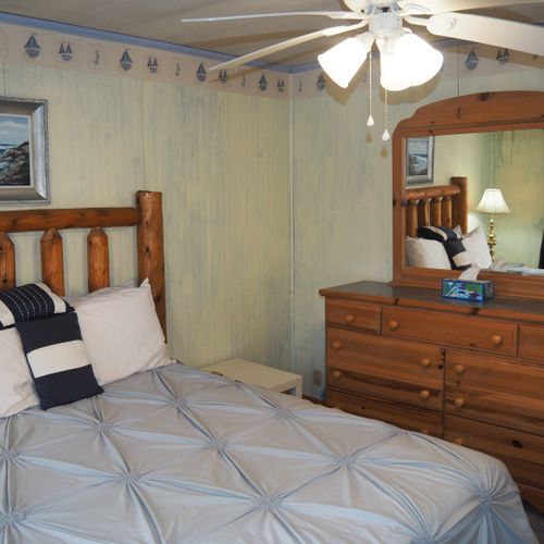 Bedroom #1 (main floor):  features a queen-size bed, private television, dresser, ceiling fan, closet, and en suite private bathroom.