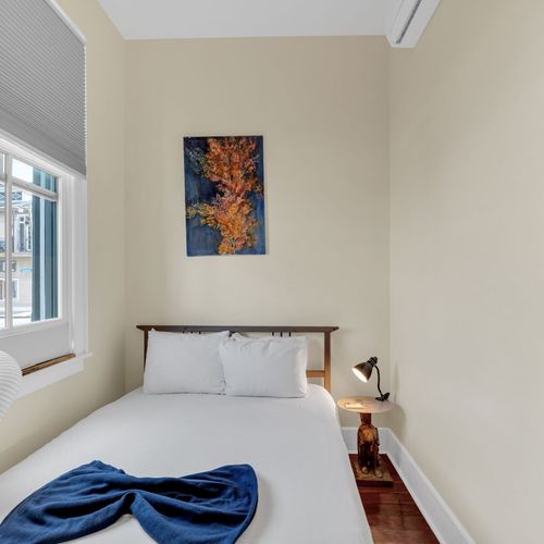 Bright, airy bedroom w/ natural light pouring in for a calm start to your day.