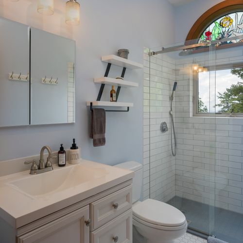 Jack and Jill full bathroom upstairs with custom-tiled shower and water views while showering!