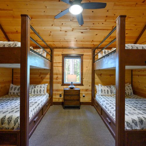 Off the loft is the bunk room featuring 4 Queen beds!
