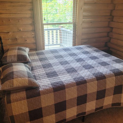 Bedroom #1:  the first of the two cute and comfy downstairs bedrooms with a queen bed, a closet, and a ceiling fan