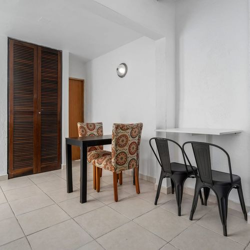 Relax in a space that boasts modern furniture, including comfortable patterned chairs and sleek black dining table.  It’s perfect for preparing simple meals and snacks during  your stay.