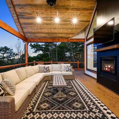 The upper level outdoor patio has an oversized sectional and gas fireplace!