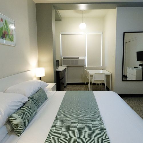 Step into comfort and relaxation! This bright and inviting bedroom offers a plush bed and ample space to unwind after a day of exploring.