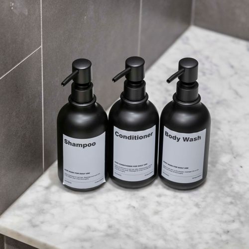 Shower niche stocked with basic bath products for guest use.