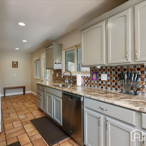 The galley kitchen space highlights contemporary counters and modern appliances.