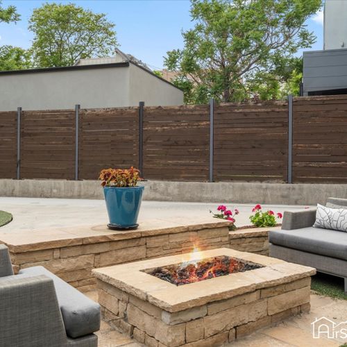 Enjoy a large fire pit surrounded by comfortable outdoor seating, perfect for cozy evenings and social gatherings.