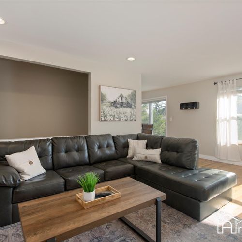 Relax and unwind in the spacious homestead inviting living room, complete with comfortable seating and plenty of natural light.