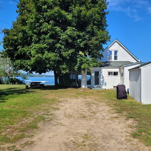 EXTERIOR:  The parking area just to the east of the cottage (inside the fence).