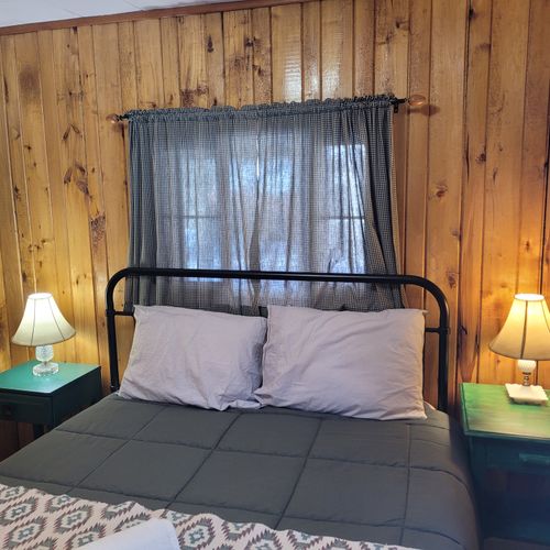 Bedroom #1:  features a queen-size bed, nightstands, lamps, a dresser, and a mirror.