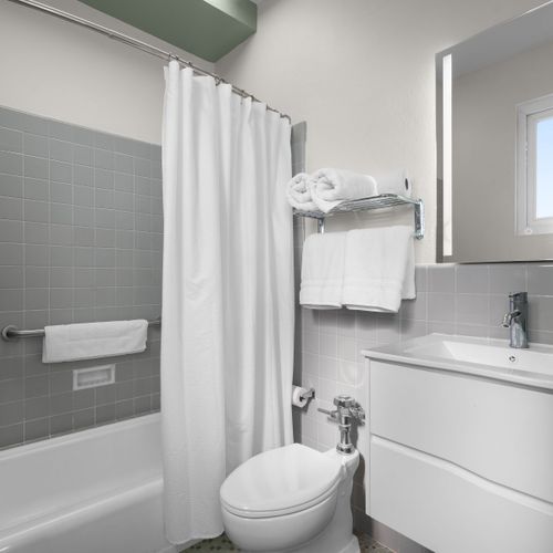 Our immaculate bathroom is always stocked with fresh, fluffy towels and essential amenities, ensuring a clean and comfortable experience for all our guests.