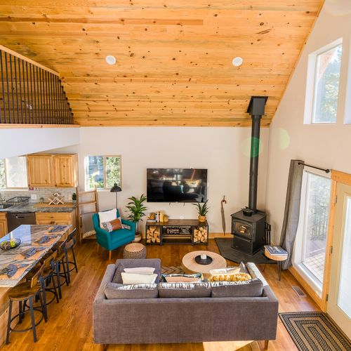 You'll fall in love with the rustic charm of this custom-built cabin and its handcrafted woodwork, grand vaulted ceilings, and breathtaking views from every window!