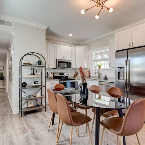 Sleek kitchen & dining area w/ a stylish table perfect for casual meals.