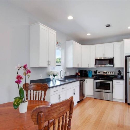 Dining area w/ a view into the kitchen — ideal for easy meals together.