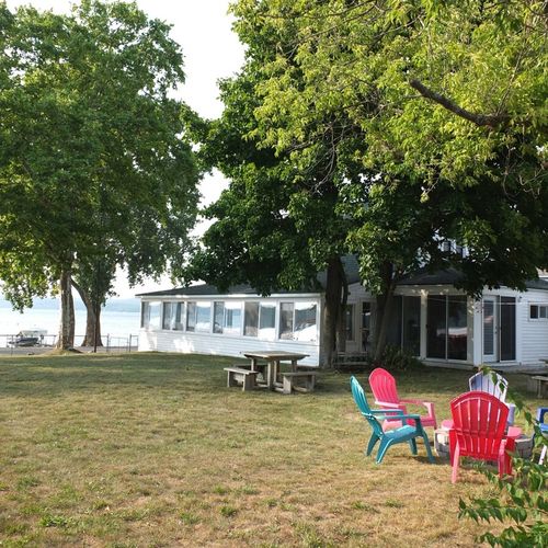 Overview:  the cottage, bonfire ring, and yard with crystal lake in the background.