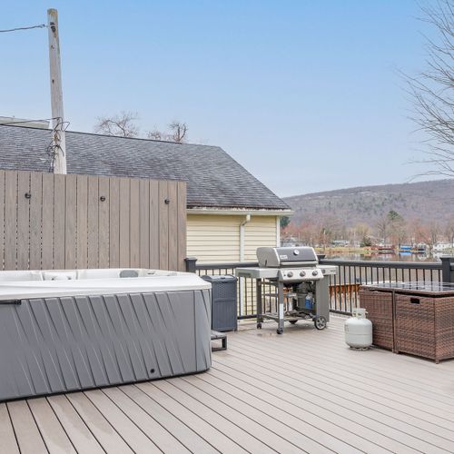 The hot tub and grill on the back deck.