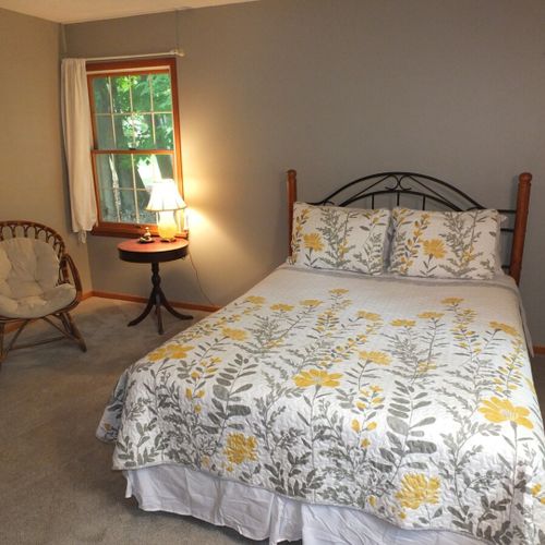 Bedroom #1:  features a queen-size bed, chair, nightstand, lamp, dresser, and 2 closets.