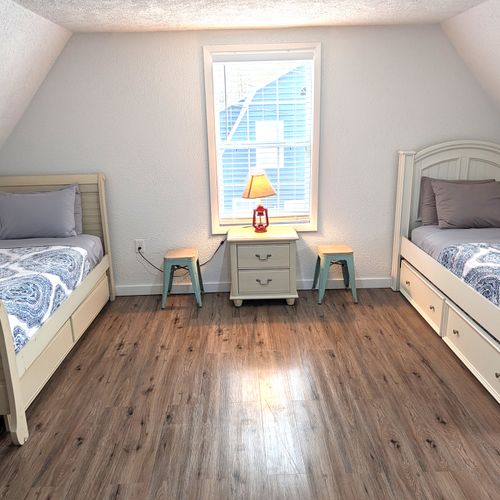 BEDROOM #4 (UPPER LEVEL):  Features 3 trundle beds, which are single beds with a second single bed that rolls out from underneath.  As such, the bedroom effectively has 6 single beds.