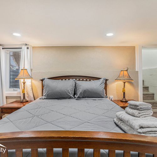The second bedroom located in the lower level comes complete with another queen-sized bed, a retreat within the home.