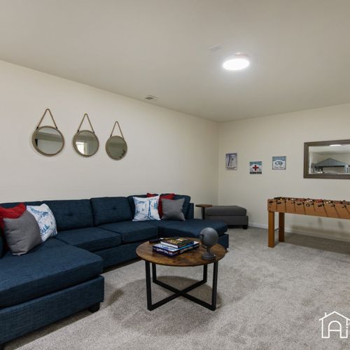 The downstairs living area is fitted with a widescreen tv, foosball and provides a cozy and comfortable space to relax, unwind and enjoy some downtime.