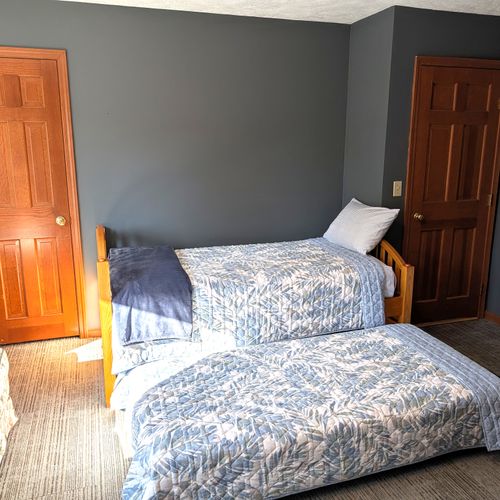 BEDROOM #5 (SECOND FLOOR):  Mixed up bedroom on the second floor with a trundle bed, loveseat, and a washer and dryer.