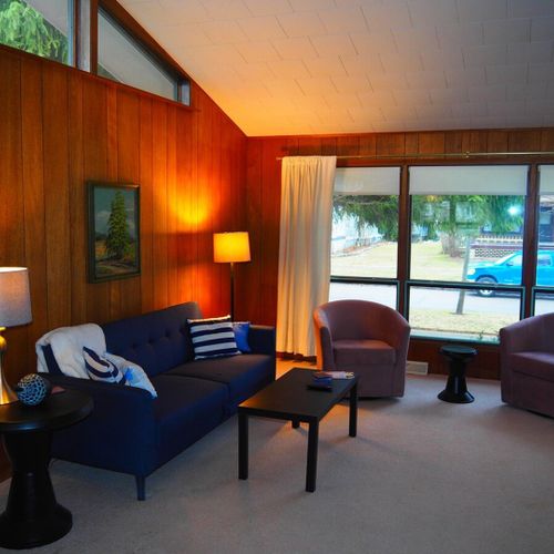 Living room:  very comfortable living room with great natural lighting, a sofa, comfy chairs, and live streaming television.