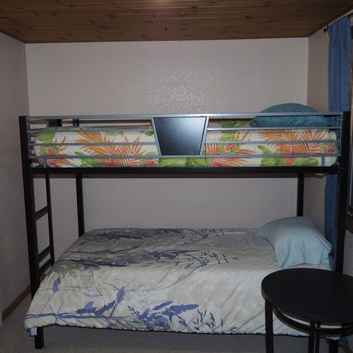 Bedroom #4 (upstairs):  features a twin-on-twin bunk bed, table, and a closet.