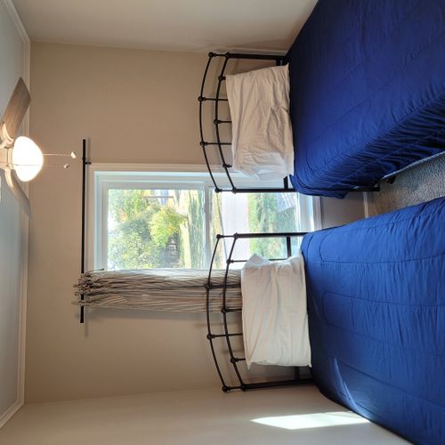 Bedroom #2:   features 2 twin beds, ceiling fan, dresser, closet, and a lamp.