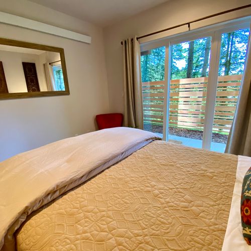 A serene retreat with its own forest-facing patio door.