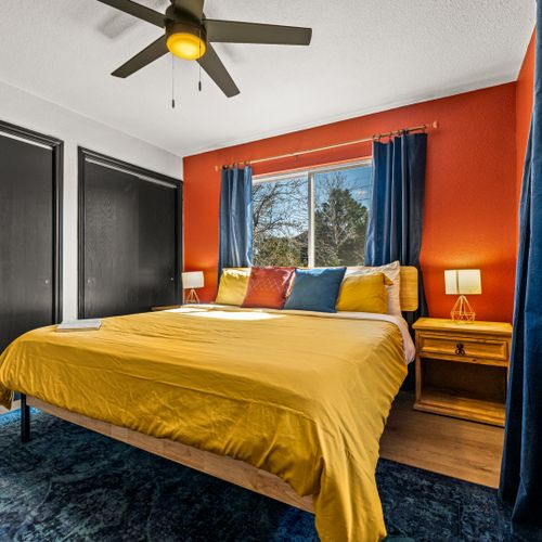 The secondary bedroom offers tons of natural light and is outfitted with a comfortable king, and side tables with lamps.