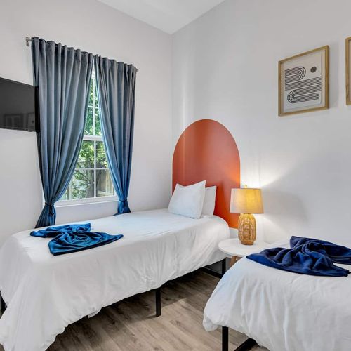 Vibrant bedroom w/ a statement headboard, soft bedding, & a warm bedside glow.