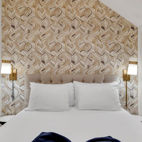Dreamy sleeping space w/ a bold feature wall & soft ambient lighting.