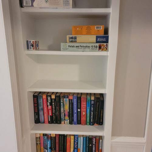 Living room:  there is a good collection of books, games, and puzzles on a shelf in the living room.