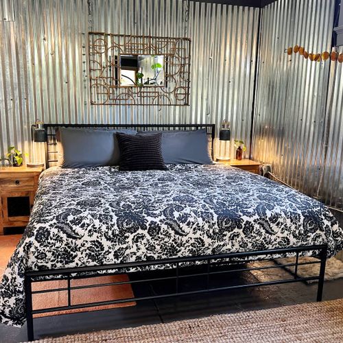 Plush king bed w/ bold patterned linens — rest well before your next adventure.