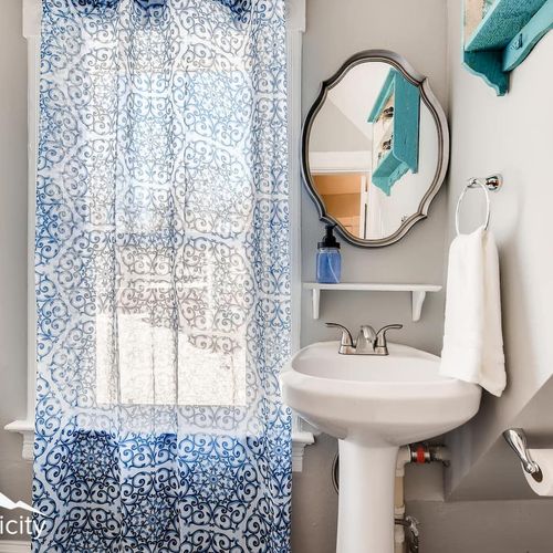 Functionality and old charm come together in this updated bathroom, fitted with a vintage-style clawfoot tub & shower feature.