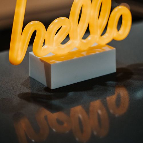 Allow the warm glow of the welcoming 'hello' to guide you towards a tranquil and comfortable experience from the moment you enter.