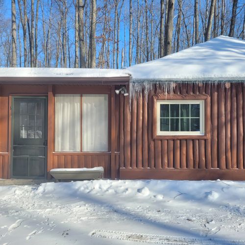 Exterior:  the side entrance to the cabin (which is the main entrance in the winter)