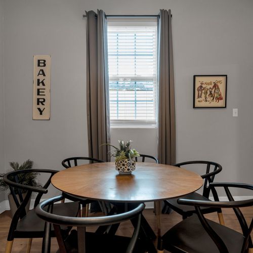 Round dining table w/ bistro chairs under warm light — a great spot for shared meals.