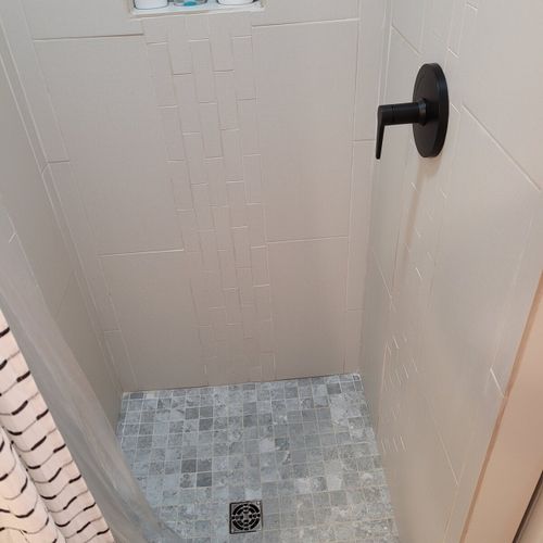 Bathroom #2:  second full bathroom that also serves as the laundry room having a stacked washer and dryer in it.