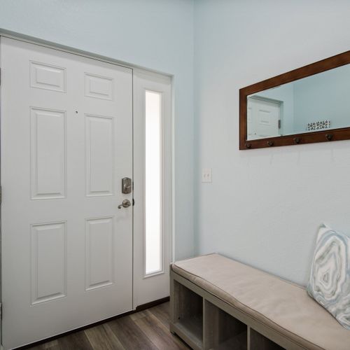 The foyer provides an open and warm entry point to this tastefully-decorated home.