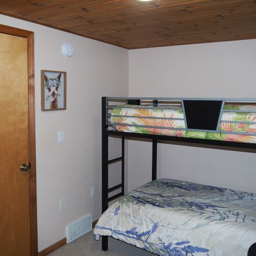 Bedroom #4 (upstairs):  features a twin-on-twin bunk bed, table, and a closet.