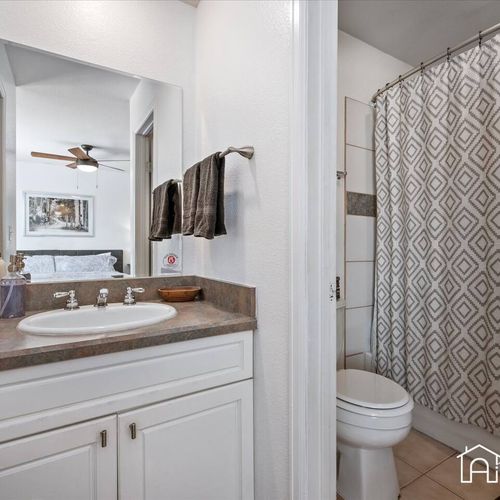 - fresh and functional bathroom with sleek tile shower, vanity sink, and neutral tones
- soft lighting and plenty of counter space make getting ready a breeze
- convenient layout just steps from the bedroom for added privacy and ease