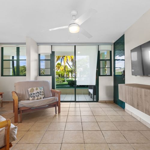 A comfortable sofa and large windows for a peaceful afternoon.