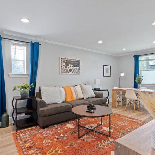Cozy living & dining area w/ warm tones, perfect for gathering after a long day.