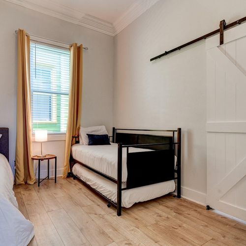 Second bedroom w/ two twin beds & a full — flexible sleeping for any group mix.