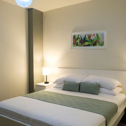 This well-appointed space combines comfort with convenience, offering a cozy bed, a small table for your essentials, and ample storage for your belongings.